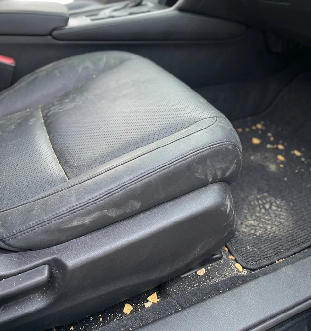 Car interior leather seat and floor mat with everyday dust before cleaning